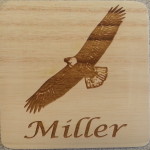 A wooden coaster with an eagle on it.